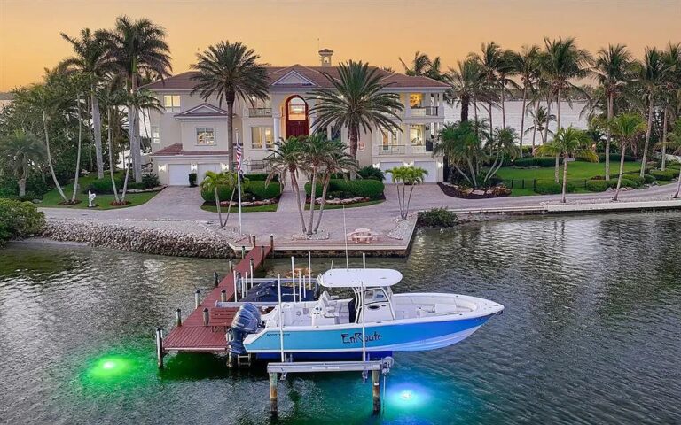 Siesta Key waterfront estate with a private dock and boat lift at dusk